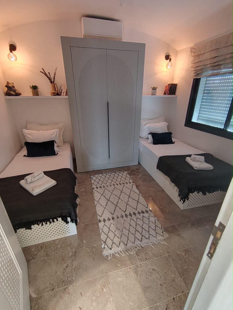 Twin bedroom with wardrobe and patterned rug
